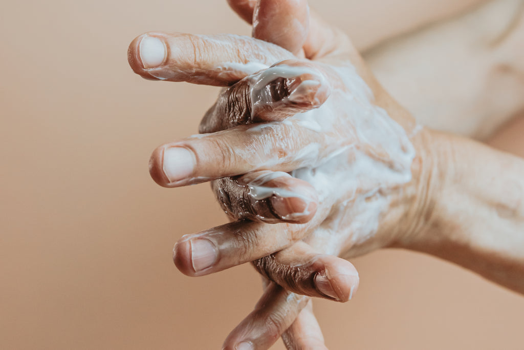 files/hands-lathered-in-hand-cream-against-beige-background.jpg